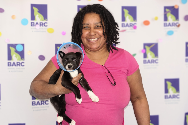 adopter holding a puppy